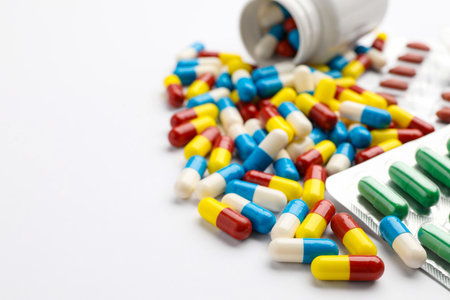 Many different pills on white background, closeup. Space for text