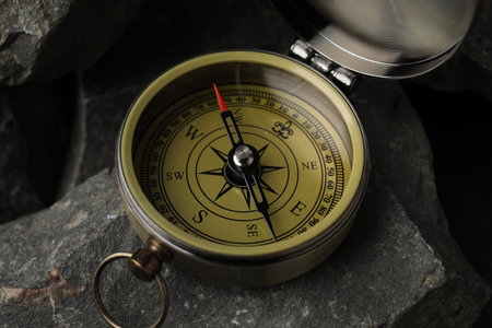 One vintage compass on stones, closeup view