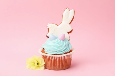 Tasty cupcake with Easter decor on pink background, closeup