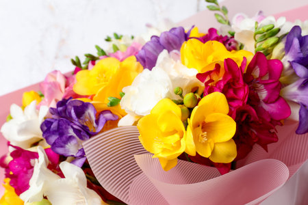 Beautiful bouquet of colorful freesia flowers on white background, closeupの写真素材