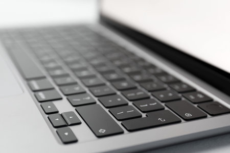 One silver laptop with keyboard, closeup. Modern device