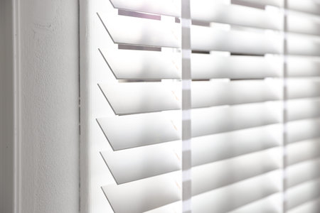Window with closed blinds indoors, closeup view