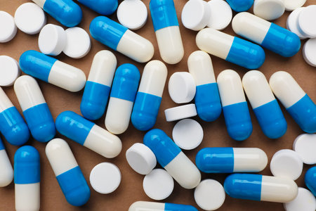 Many pills on brown background, flat lay