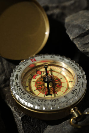 One vintage compass on stones, closeup view
