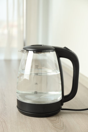 Electric kettle on wooden table indoors, closeupの写真素材