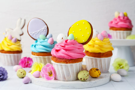 Tasty cupcakes with Easter decor on white table, closeup