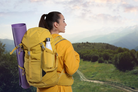 Woman with backpack enjoying mountain view. Active lifestyle