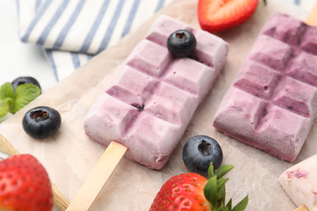 Tasty frozen yogurt and berries on table, closeup