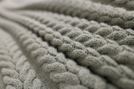 Soft knitted plaid as background, closeup view