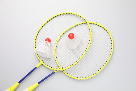 Badminton rackets and shuttlecocks on white background, top viewの写真素材