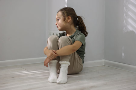 Autism. Little girl with ASD near light wall indoorsの写真素材