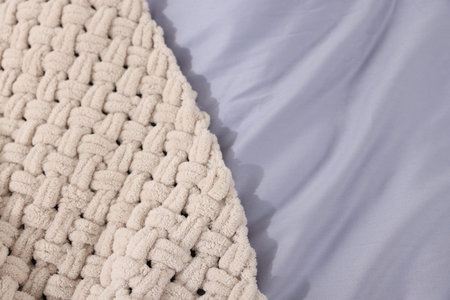 Clean bed linens and plaid as background, closeup