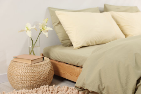 Comfortable bed with fresh cotton linens indoors, closeup