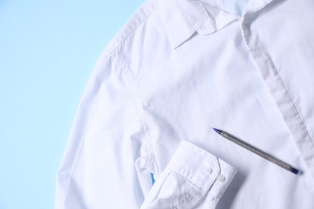 Messy shirt on light blue background, closeup