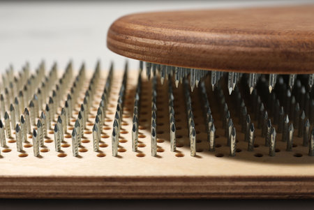 Nail standing practice. Sadhu boards on light background, closeup