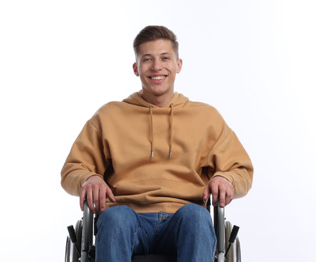 Happy man in wheelchair on white background