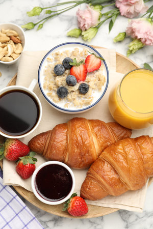 Healthy breakfast. Flat lay composition with tasty croissants and oatmeal with berries on white...