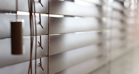 Window with closed blinds indoors, closeup view
