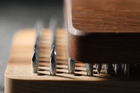 Nail standing practice. Sadhu boards on gray background, closeup