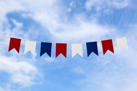 Bunting in colors of USA flag against blue sky. Festive decoration