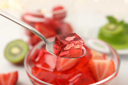 Taking piece of tasty jelly at table, closeup