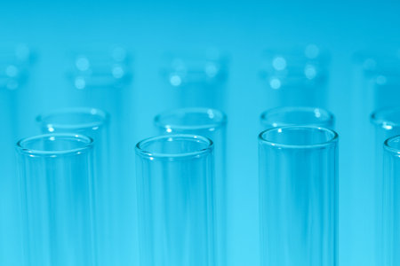 Many test tubes on blue background, closeup