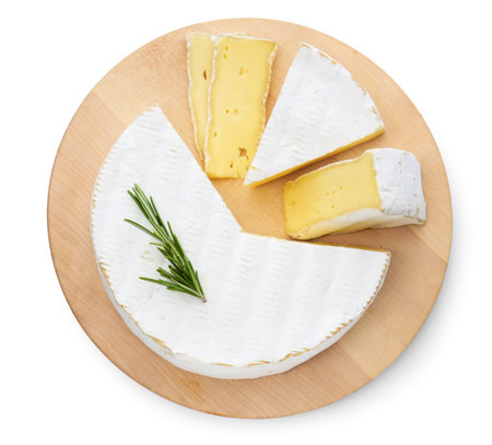 Pieces of delicious brie cheese with rosemary isolated on white, top view