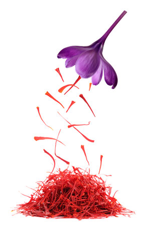 Saffron falling from crocus flower onto heap on white background. Aromatic spice