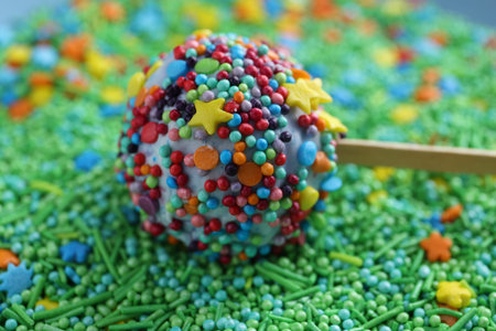 One tasty cake pop on sprinkles, closeup