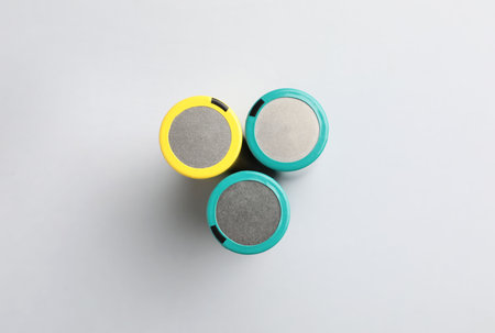 Many alkaline batteries on light grey background, flat lay