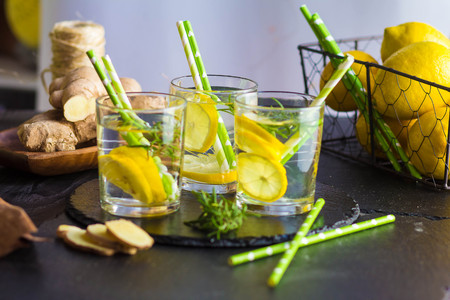 Ingredients for making flu fighting natural hot drink. Oranges, mint, lemons, ginger, honey, apple...
