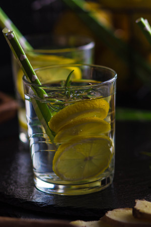 Ingredients for making flu fighting natural hot drink. Oranges, mint, lemons, ginger, honey, apple and spices over plywood background, top view, copy space. Clean eating, detox, dieting conceptの写真素材