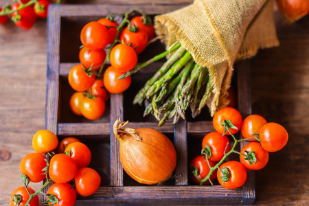 Fresh raw asparagus and other spring vegetables cooking in the kitchen, top viewの写真素材