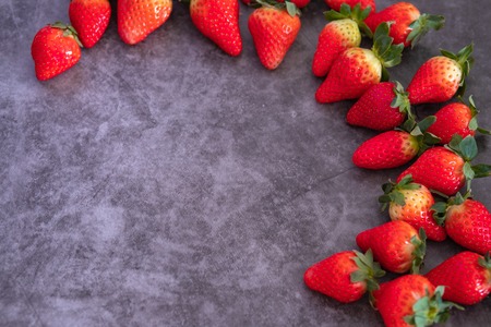 Strawberries on black background. Place to text.