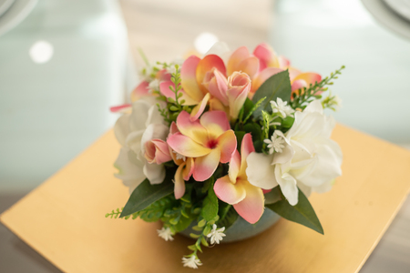 glass table setting with flower arrangement and fruitの写真素材