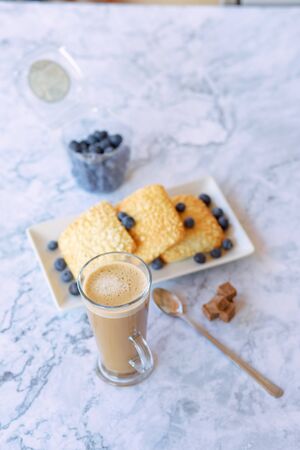prepares coffee with milk with ciabatta in his coffee shopの写真素材