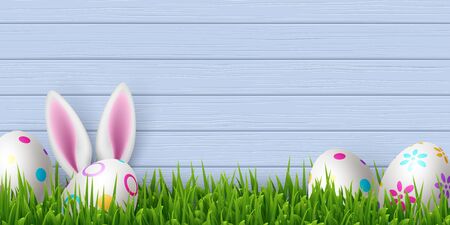 Vector Easter banner with painted eggs, green grass and cute rabbit ears. Blue wooden background...