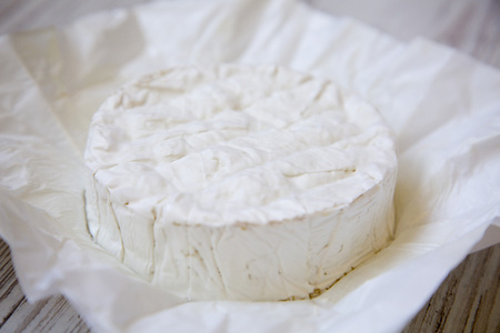 Camembert cheese on paper. Food for wine, closeup. の写真素材