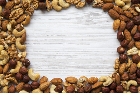 Mixed nuts frame. Cashew, hazelnuts, walnuts, almonds. Top view. Copy space.の写真素材