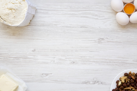 Ingredients for making cookies on white wooden background. Top view. From above, flat lay. Copy...