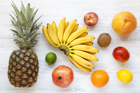 Set of various exotic fruits over white wooden background, top view.の写真素材