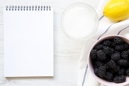 Ingredients for blackberries jam with blank notebook on white wooden table, top view. From above, overhead.の写真素材
