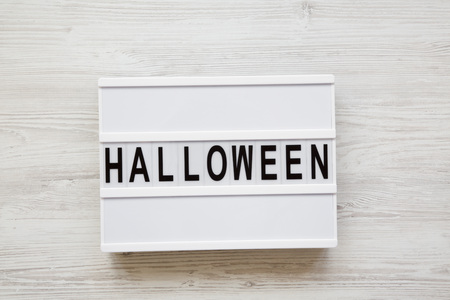 'Halloween' word on lightbox over white wooden background, top view. From above, overhead.の写真素材