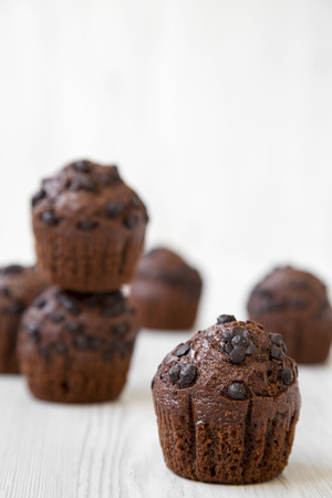 Chocolate muffins on white wooden surface, side view. Selective focus.の写真素材