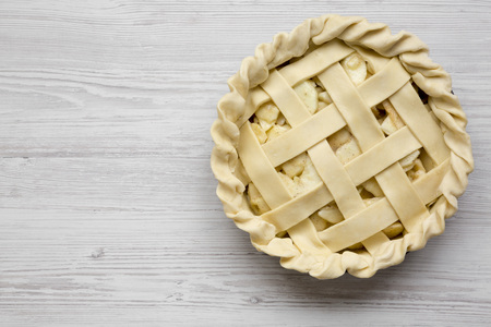 Apple pie on a white wooden table, overhead view. Copy space.の写真素材