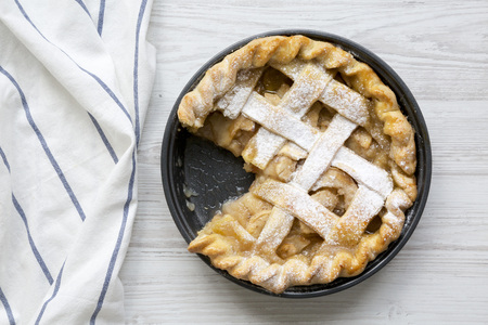 Home-baked apple pie on white wooden surface, top view. Flat lay, overhead, from above. Closeup.の写真素材