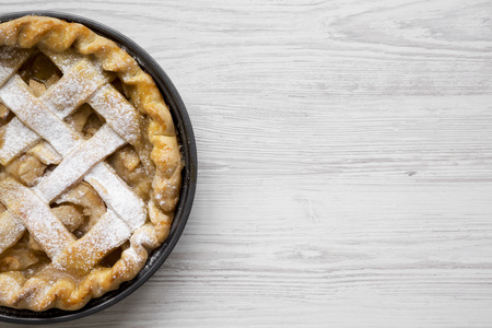 Home-baked apple pie on white wooden background, top view. Flat lay, overhead, from above. Space for text.の写真素材