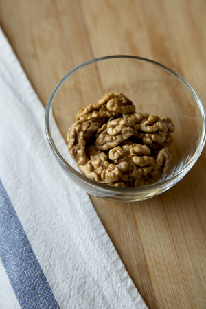 Walnuts in glass bowl, low angle view.の写真素材