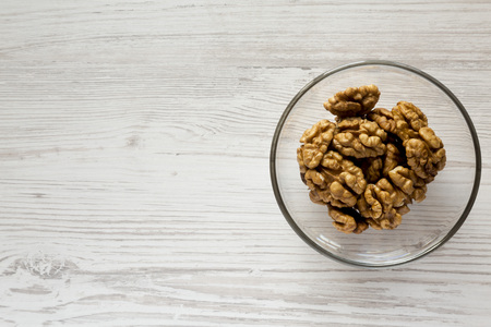 Walnuts in glass bowl, top view. Copy space. Flat lay, overhead, from above.の写真素材