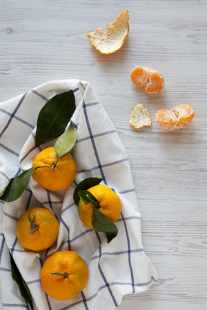 Fresh ripe tangerines on a white wooden background, view from above. Flat lay, top view.の写真素材